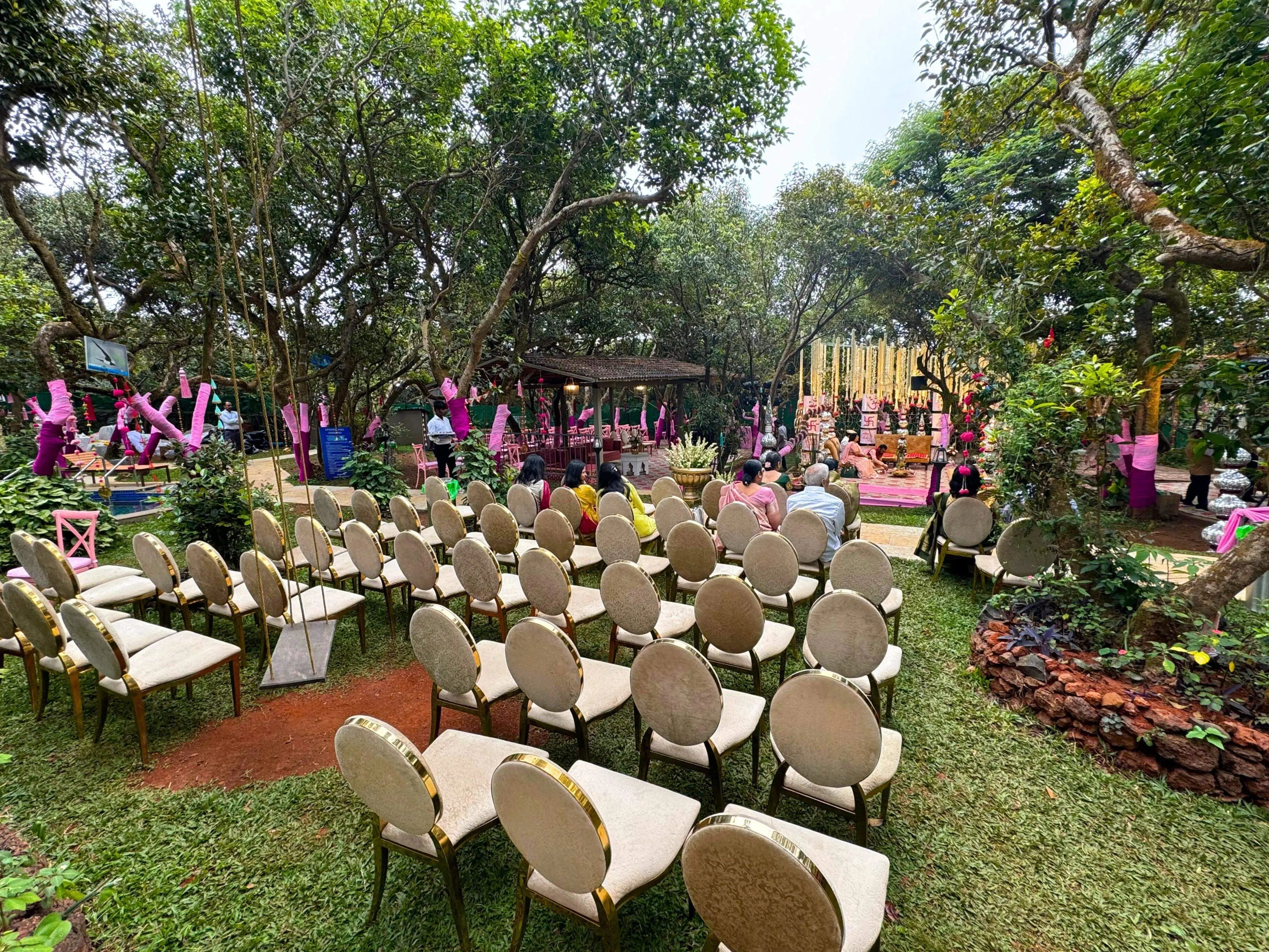 Wedding ceremony setup under a tree canopy with colorful decor and seating at Ramsukh Resort, Mahabaleshwar.